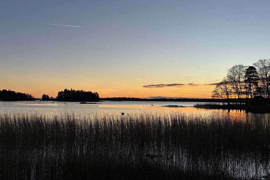 Calm sunset over Nordic lake symbolizing leadership clarity and grounded decision-making.